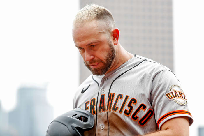 SF Giants third baseman Evan Longoria walks to the dugout.
